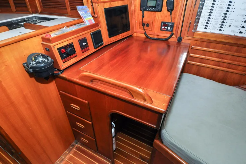 Slide: The Image of Navigation station on 1986 Hinckley Sou'wester 51 yacht with wooden desk and control panels. - 87