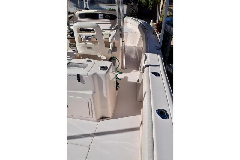 Slide: The Image of 2006 Grady-White Bimini 306 boat interior with helm and seating area. - 14