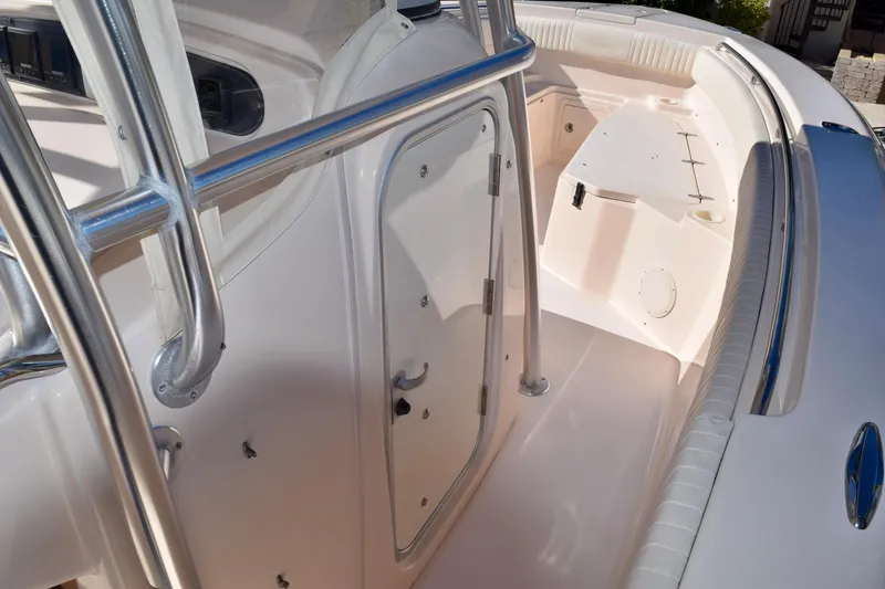 Slide: The Image of 2006 Grady-White Bimini 306 boat interior with stainless steel railings and seating area. - 15