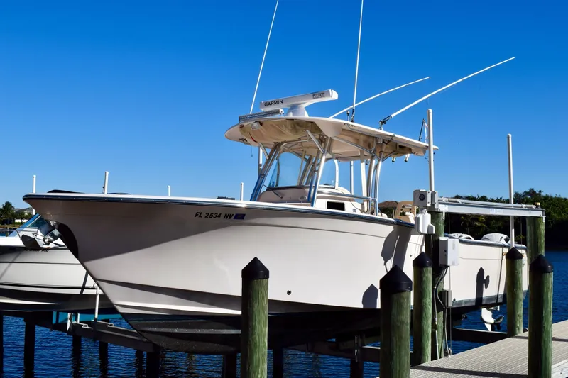 Slide: The Image of 2006 Grady-White Bimini 306 boat docked under clear blue sky. - 2