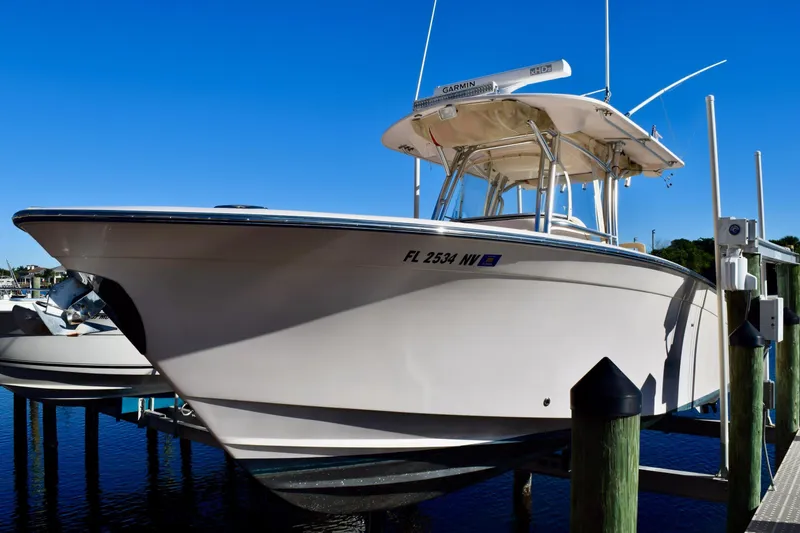 Slide: The Image of 2006 Grady-White Bimini 306 boat docked under clear blue sky. - 3
