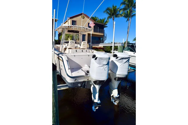 Slide: The Image of 2006 Grady-White Bimini 306 boat docked with covered outboard motors. - 4