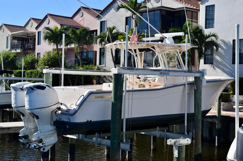 Slide: The Image of 2006 Grady-White Bimini 306 boat docked near waterfront homes with palm trees. - 5