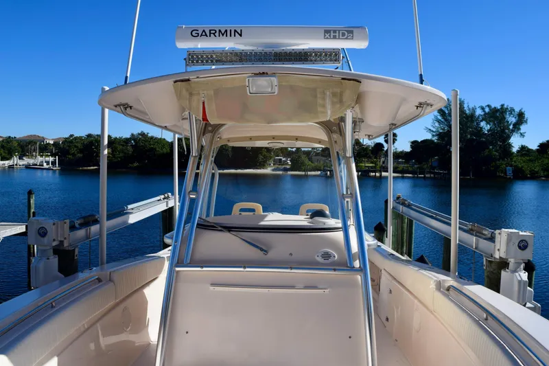 Slide: The Image of 2006 Grady-White Bimini 306 boat docked on a serene lake with clear blue skies. - 7