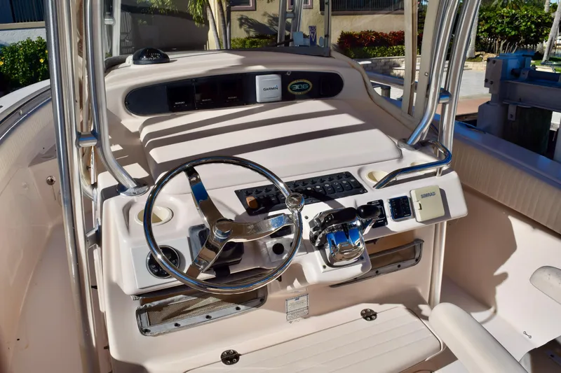 Slide: The Image of 2006 Grady-White Bimini 306 boat console with steering wheel and navigation equipment. - 8