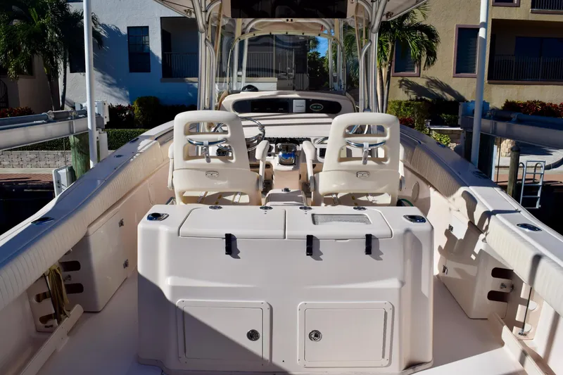 Slide: The Image of 2006 Grady-White Bimini 306 boat interior with dual helm seats and spacious deck. - 9