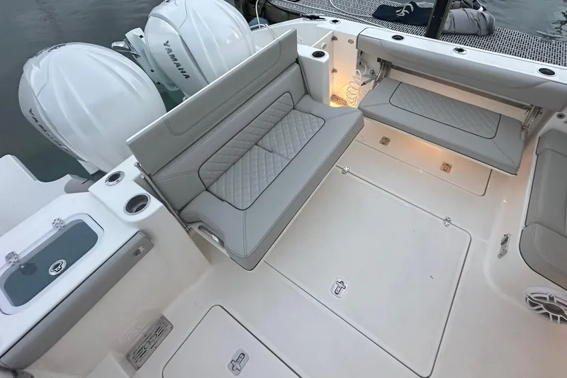 Slide: The Image of 2023 Pursuit DC 326 Dual Console boat on calm water at sunset. - 10