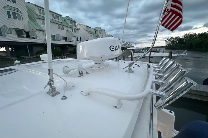 Slide: The Image of 2023 Pursuit DC 326 Dual Console boat cruising on calm water at sunset. - 11