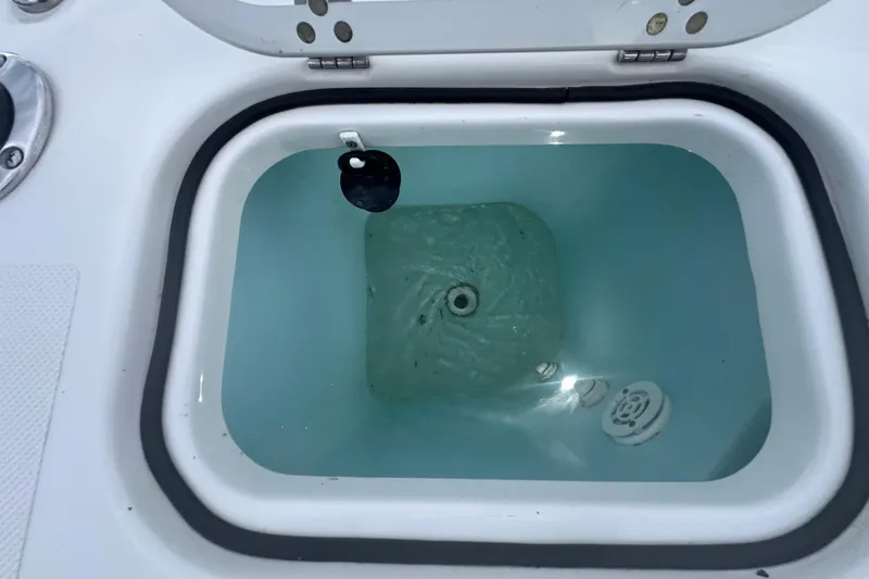 Slide: The Image of 2023 Pursuit DC 326 Dual Console boat cruising on calm water at sunset. - 13