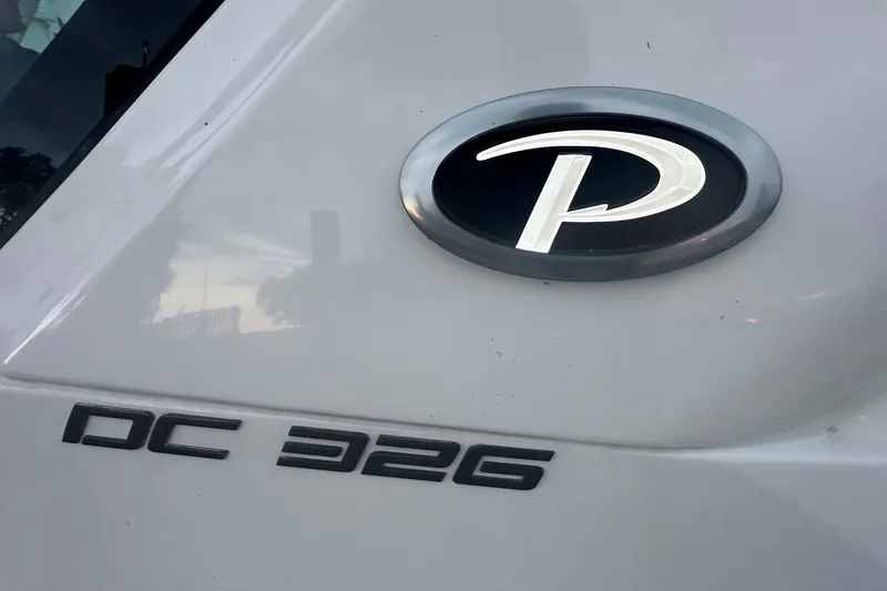 Slide: The Image of 2023 Pursuit DC 326 Dual Console interior with modern helm and seating, overlooking serene waters. - 15