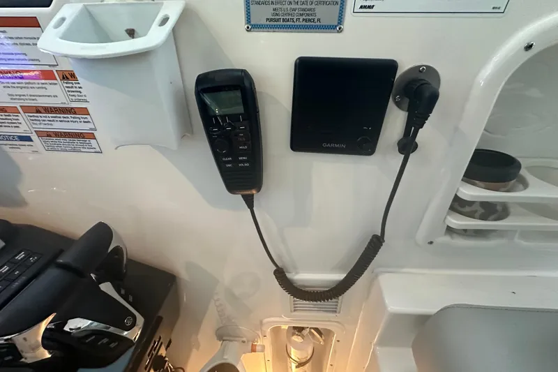 Slide: The Image of 2023 Pursuit DC 326 Dual Console boat interior with luxurious seating and ocean view. - 17