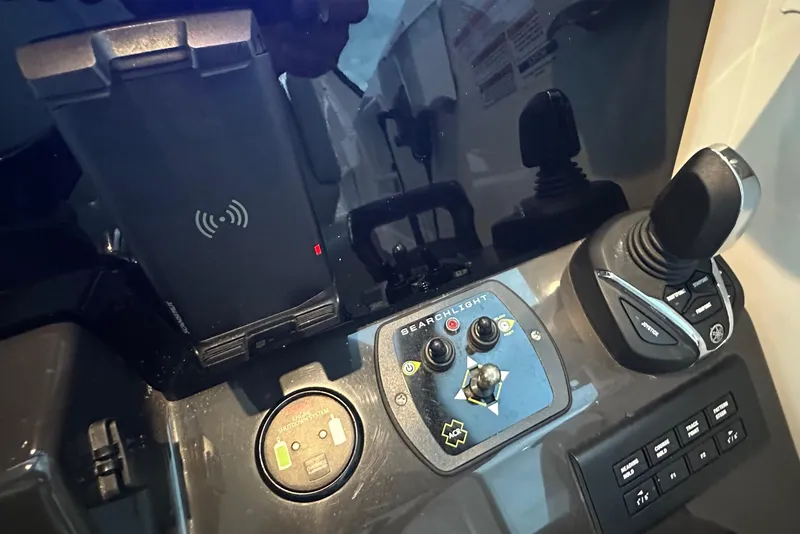 Slide: The Image of 2023 Pursuit DC 326 Dual Console interior with cushioned seating and decorative pillows. - 18