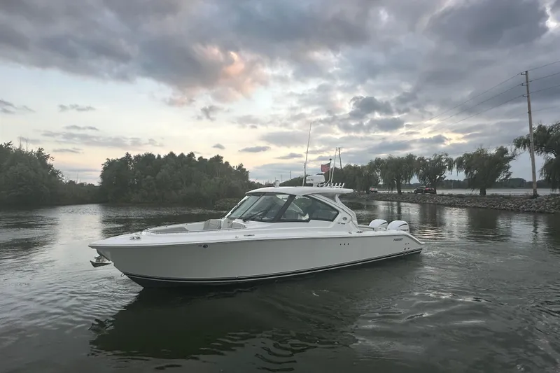 Slide: The Image of 2023 Pursuit DC 326 Dual Console boat interior with seating and Yamaha engines. - 26