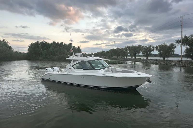 Slide: The Image of 2023 Pursuit DC 326 Dual Console boat interior with sink and storage. - 32