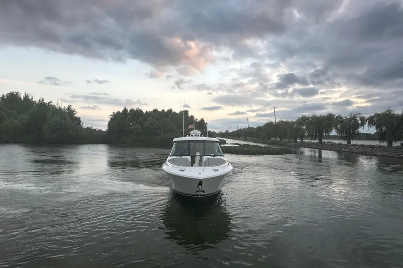 Slide: The Image of Anchor compartment of 2023 Pursuit DC 326 Dual Console boat with water access controls. - 34