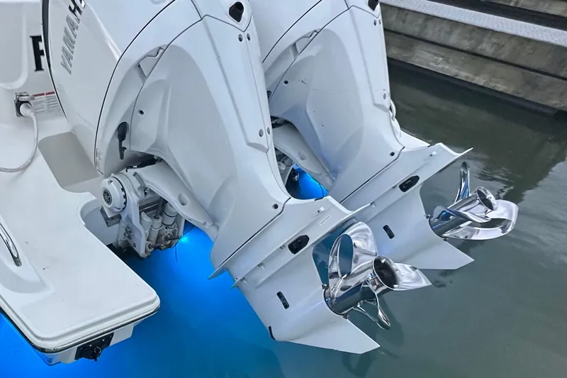 Slide: The Image of 2023 Pursuit DC 326 Dual Console boat cruising on calm water at sunset. - 6