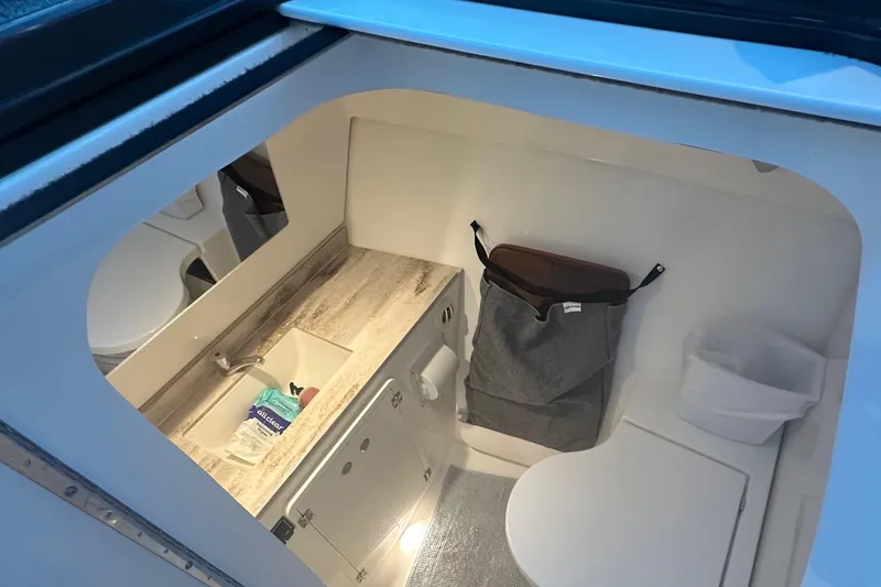 Slide: The Image of 2023 Pursuit DC 326 Dual Console boat on calm water at sunset. - 9