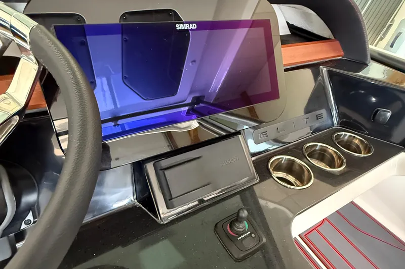 Slide: The Image of Steering wheel and dashboard of 2026 Monterey Elite 27 SD boat with Simrad display. - 10