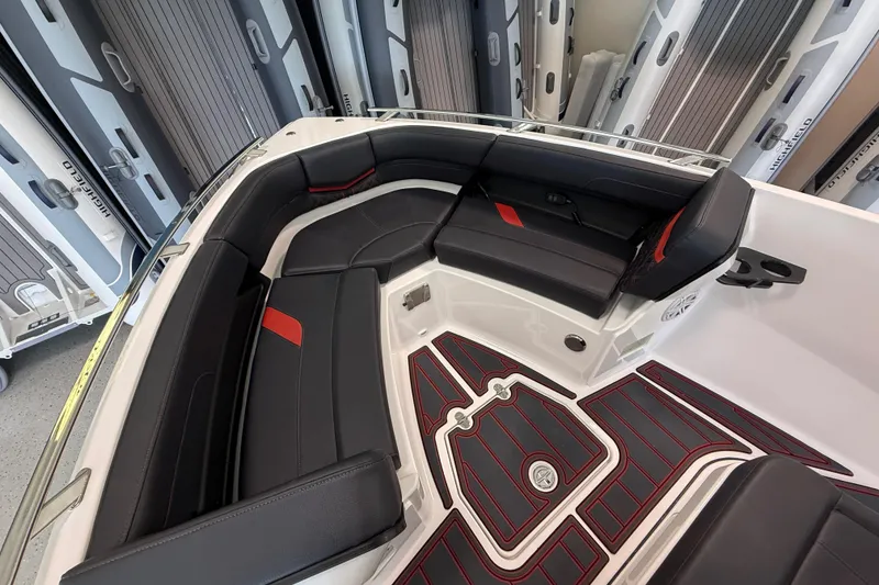 Slide: The Image of Luxurious interior of 2026 Monterey Elite 27 SD boat with sleek black and red seating. - 17