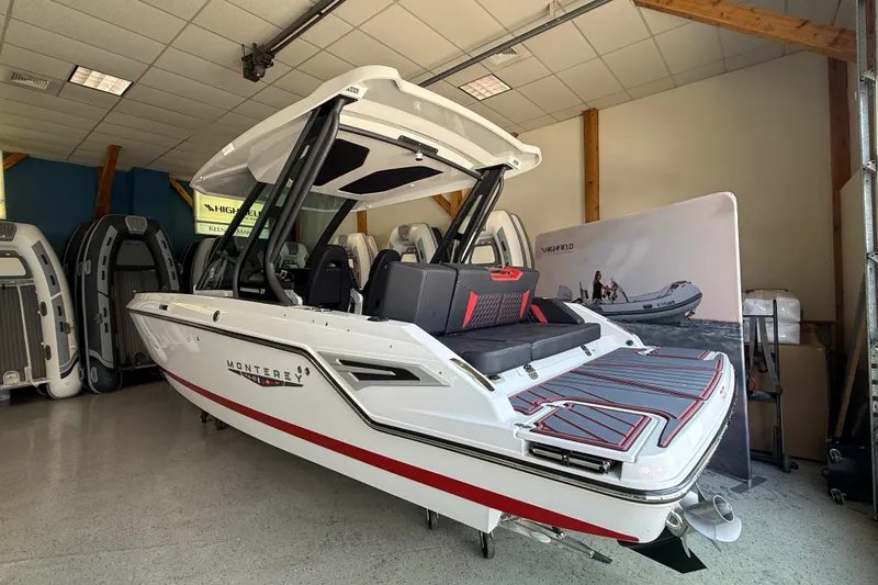 Slide: The Image of 2026 Monterey Elite 27 SD boat displayed indoors, featuring sleek design and modern seating. - 3