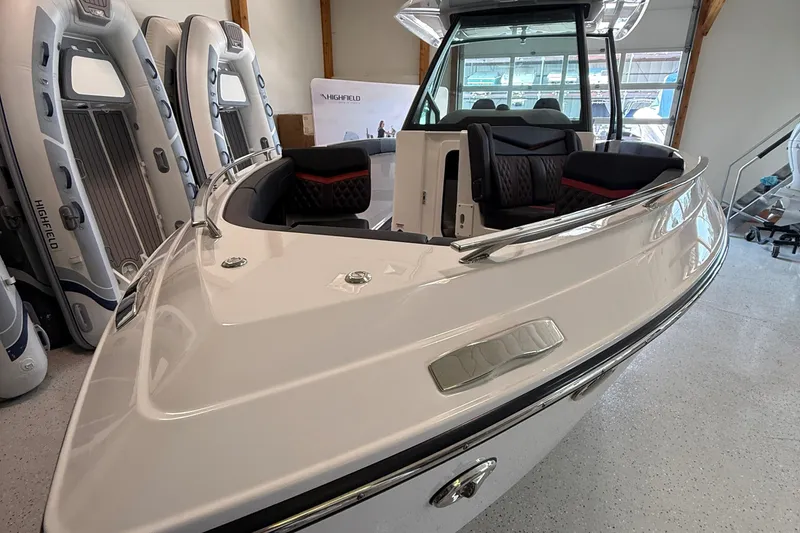 Slide: The Image of 2026 Monterey Elite 27 SD boat in showroom, featuring sleek design and luxurious seating. - 4