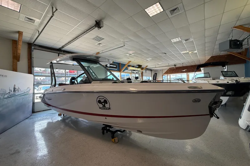 Slide: The Image of 2026 Monterey Elite 27 SD boat displayed in a showroom with modern interior. - 5