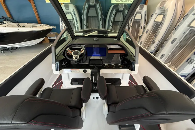 Slide: The Image of 2026 Monterey Elite 27 SD boat interior with modern dashboard and black leather seats. - 9