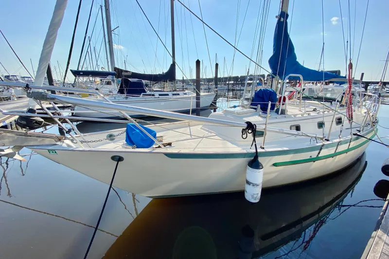 The Image of 1993 Pacific Seacraft 34 sailboat docked in a marina, surrounded by other vessels. - 1
