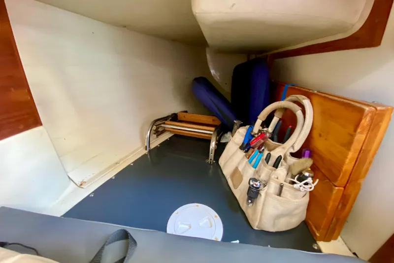 Slide: The Image of Interior storage area of a 1993 Pacific Seacraft 34 sailboat with tools and equipment. - 10