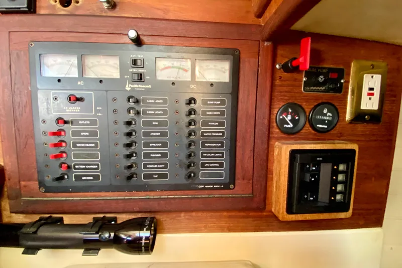 Slide: The Image of Electrical control panel of a 1993 Pacific Seacraft 34 sailboat with switches and gauges. - 11
