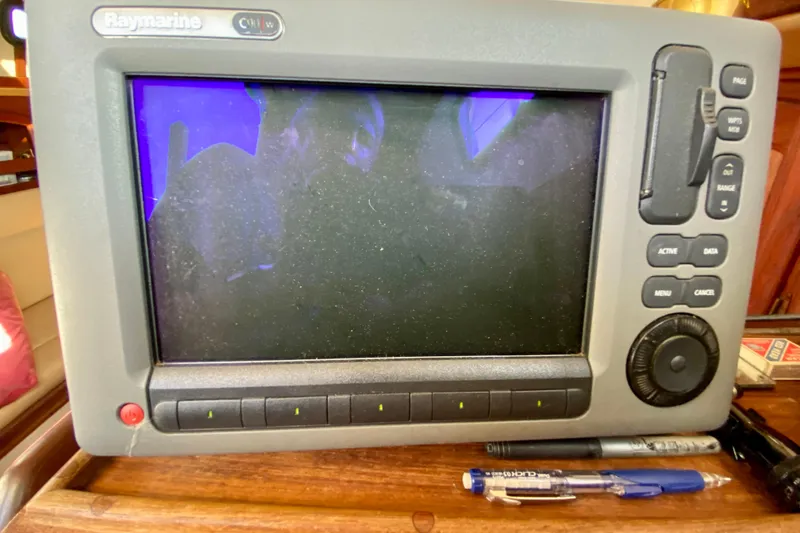 Slide: The Image of Raymarine navigation system on 1993 Pacific Seacraft 34 sailboat, with pens nearby. - 13