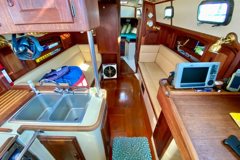 Slide: The Image of Interior of 1993 Pacific Seacraft 34 sailboat with wood finish and modern amenities. - 14