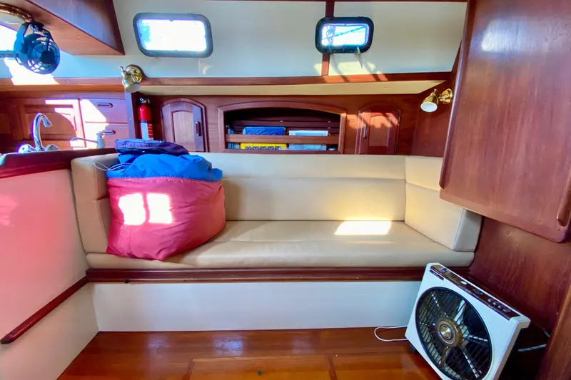 Slide: The Image of Cozy interior of a 1993 Pacific Seacraft 34 sailboat with seating and fan. - 15