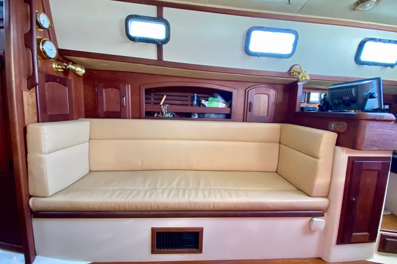 Slide: The Image of Interior of 1993 Pacific Seacraft 34 sailboat with beige seating and wooden accents. - 16