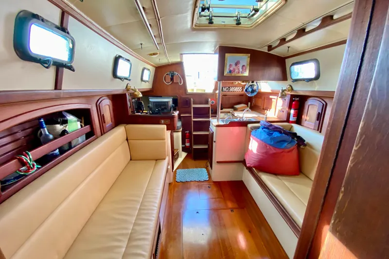 Slide: The Image of Interior of 1993 Pacific Seacraft 34 sailboat with cozy seating and wooden finishes. - 20