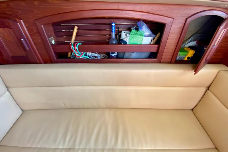 Slide: The Image of Interior of 1993 Pacific Seacraft 34 sailboat with wooden storage and beige seating. - 23