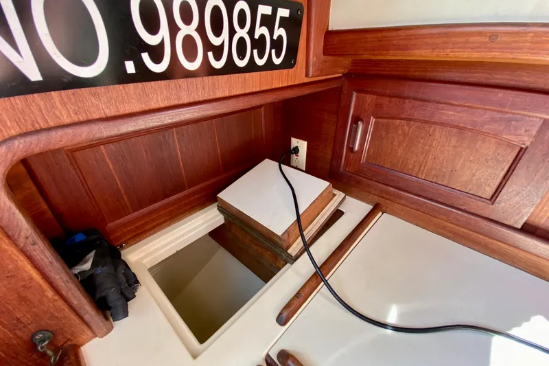 Slide: The Image of Interior of 1993 Pacific Seacraft 34 sailboat with wooden cabinetry and electrical outlet. - 25