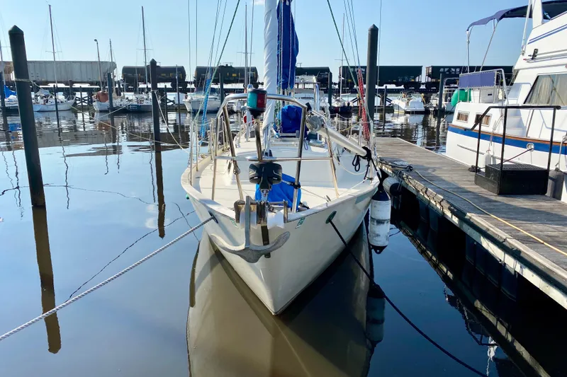 Slide: The Image of 1993 Pacific Seacraft 34 sailboat docked at marina, calm water reflections. - 27