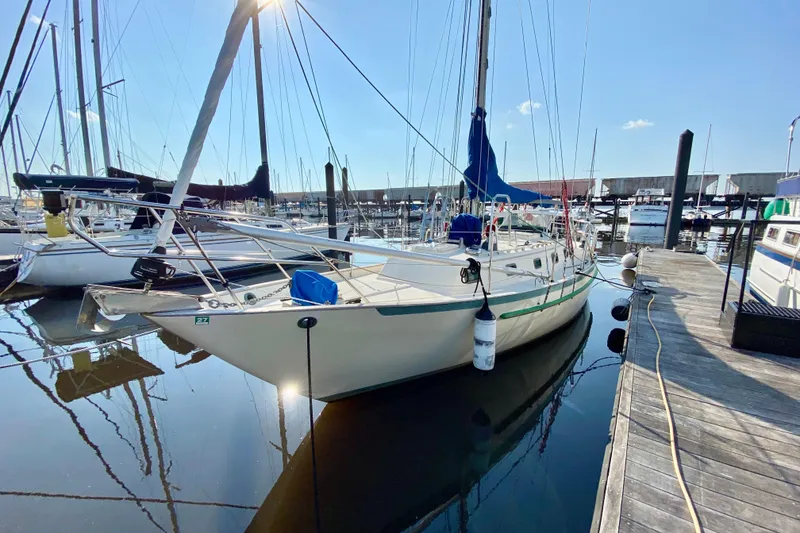 Slide: The Image of 1993 Pacific Seacraft 34 sailboat docked at marina under clear blue sky. - 28
