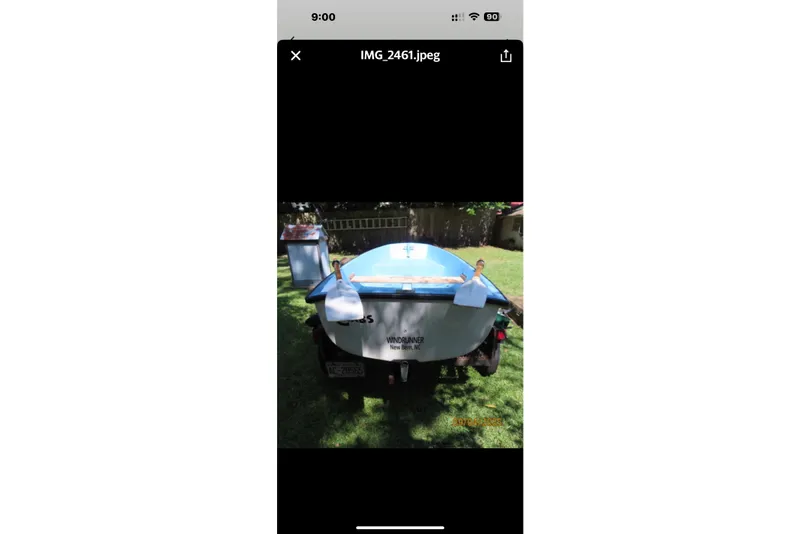 Slide: The Image of 1993 Pacific Seacraft 34 boat on trailer, parked on grass in a backyard setting. - 31