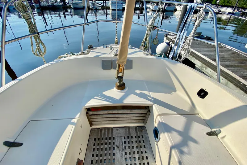 Slide: The Image of Cockpit of 1993 Pacific Seacraft 34 sailboat docked at marina, featuring clean deck and rigging. - 5