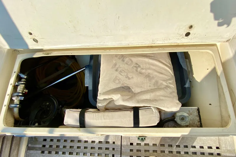 Slide: The Image of Storage compartment of a 1993 Pacific Seacraft 34 sailboat with equipment and supplies. - 7