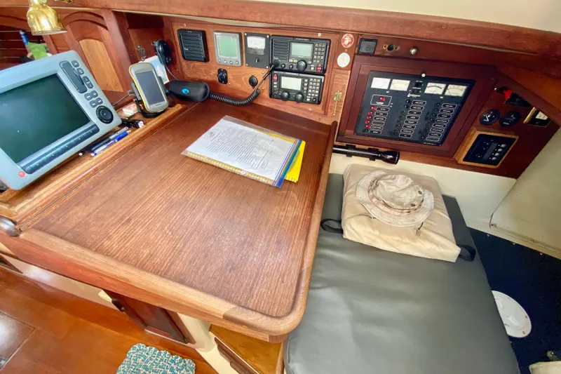 Slide: The Image of Navigation station of 1993 Pacific Seacraft 34 sailboat with electronics and chart table. - 9