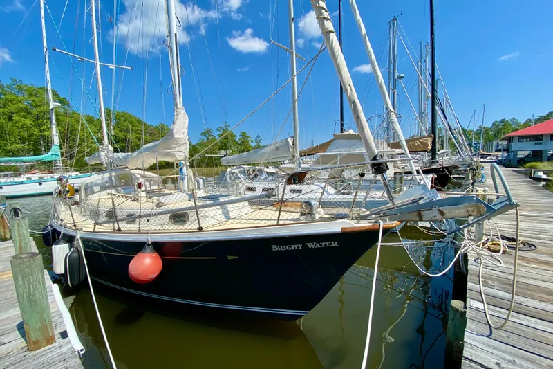 The Image of 1977 Allied Princess Cutter sailboat docked at marina under clear blue sky. - 1