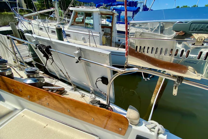 Slide: The Image of 1977 Allied Princess Cutter sailboat docked, featuring deck details and equipment. - 11