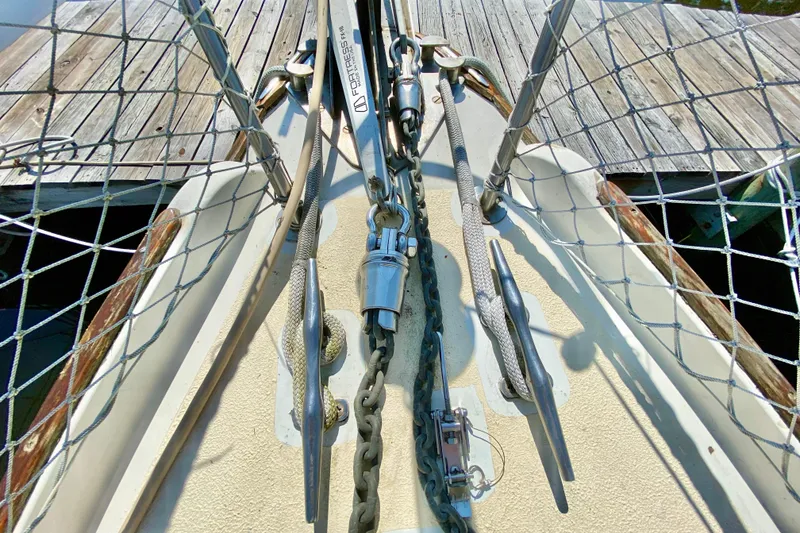 Slide: The Image of Bow of 1977 Allied Princess Cutter sailboat with anchor chain and deck fittings. - 13