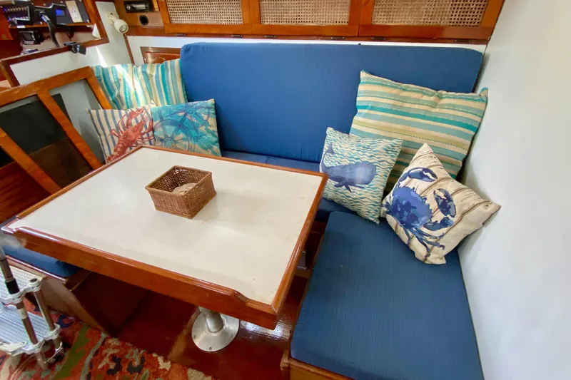 Slide: The Image of Cozy 1977 Allied Princess Cutter interior with blue seating and nautical-themed pillows. - 19