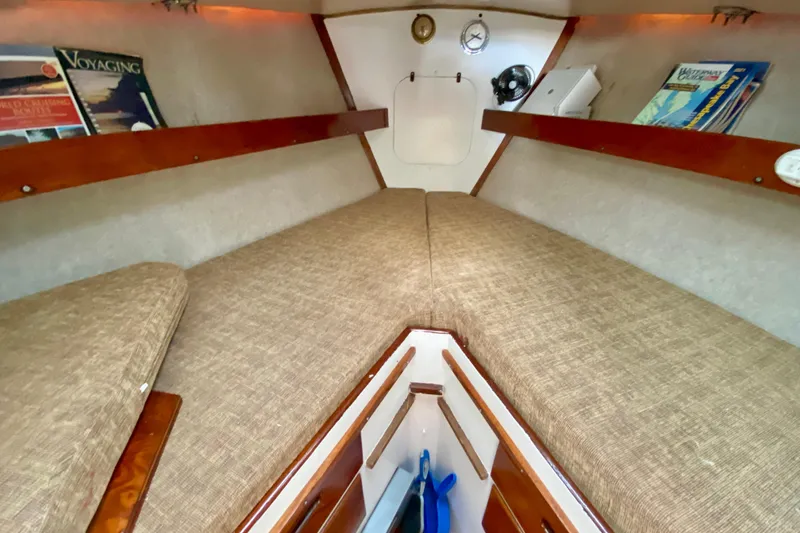 Slide: The Image of 1977 Allied Princess Cutter cabin interior with cozy bedding and wooden shelves. - 20