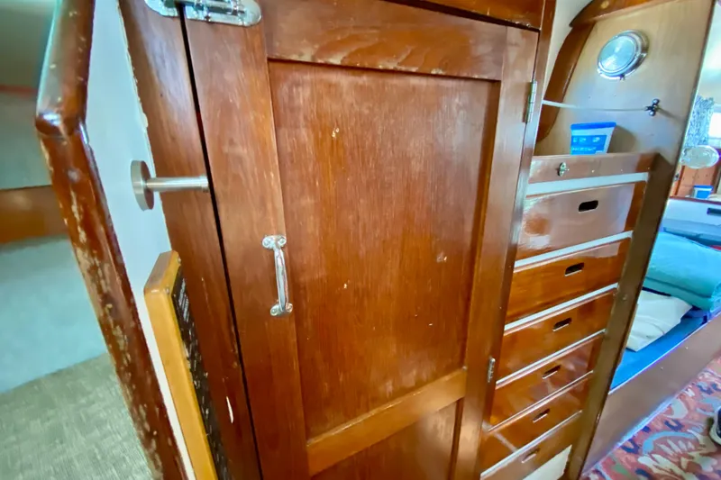 Slide: The Image of Wooden interior of 1977 Allied Princess Cutter with storage drawers and cozy cabin space. - 23