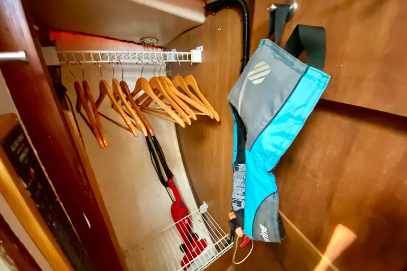 Slide: The Image of Wooden closet with hangers, life jacket, and cleaning tools on Allied Princess Cutter, 1977. - 24